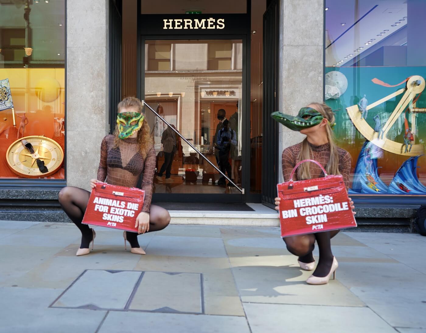 London, England, UK. 28th May, 2022. A protester holds an inflatable  crocodile outside Hermes. Animal rights activists gathered outside the  Hermes store in Bond Street in protest against the use of crocodile